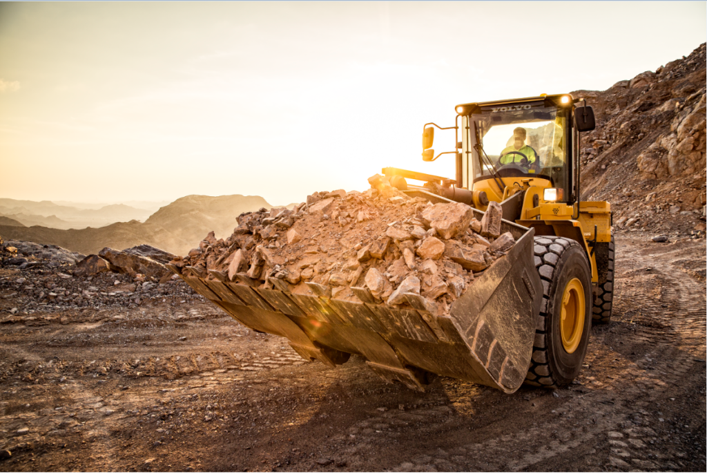 Quarry worker moving a pile of aggregates. Copyright of Volvo